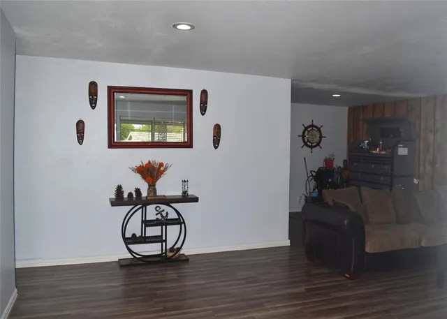 a view of a livingroom with furniture and hardwood floor