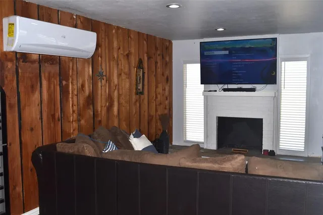 a living room with a fireplace furniture and a flat screen tv