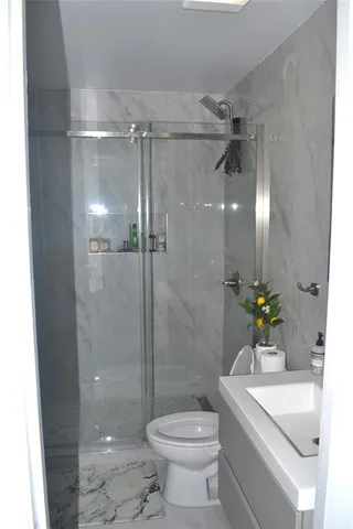 a bathroom with a sink toilet and shower