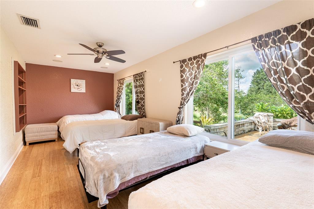 18301 South Obrien Road Groveland, FL 34736 - Photo 13 of 35 a bedroom with two beds and a large window