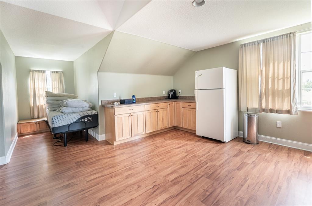 18301 South Obrien Road Groveland, FL 34736 - Photo 27 of 35 a kitchen with stainless steel appliances kitchen island wooden floors and white walls
