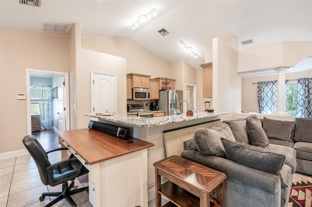18301 South Obrien Road Groveland, FL 34736 - Photo 8 of 35 a living room with stainless steel appliances kitchen island granite countertop furniture and a large window