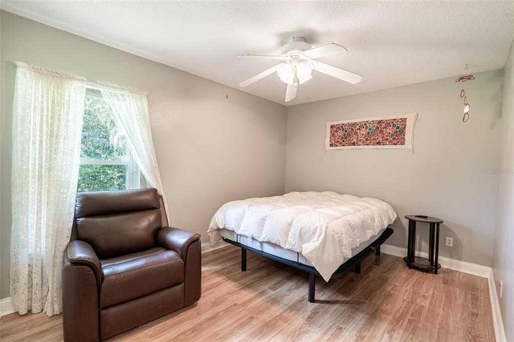 18301 South Obrien Road Groveland, FL 34736 - Photo 10 of 35 a bedroom with a bed couch and a window