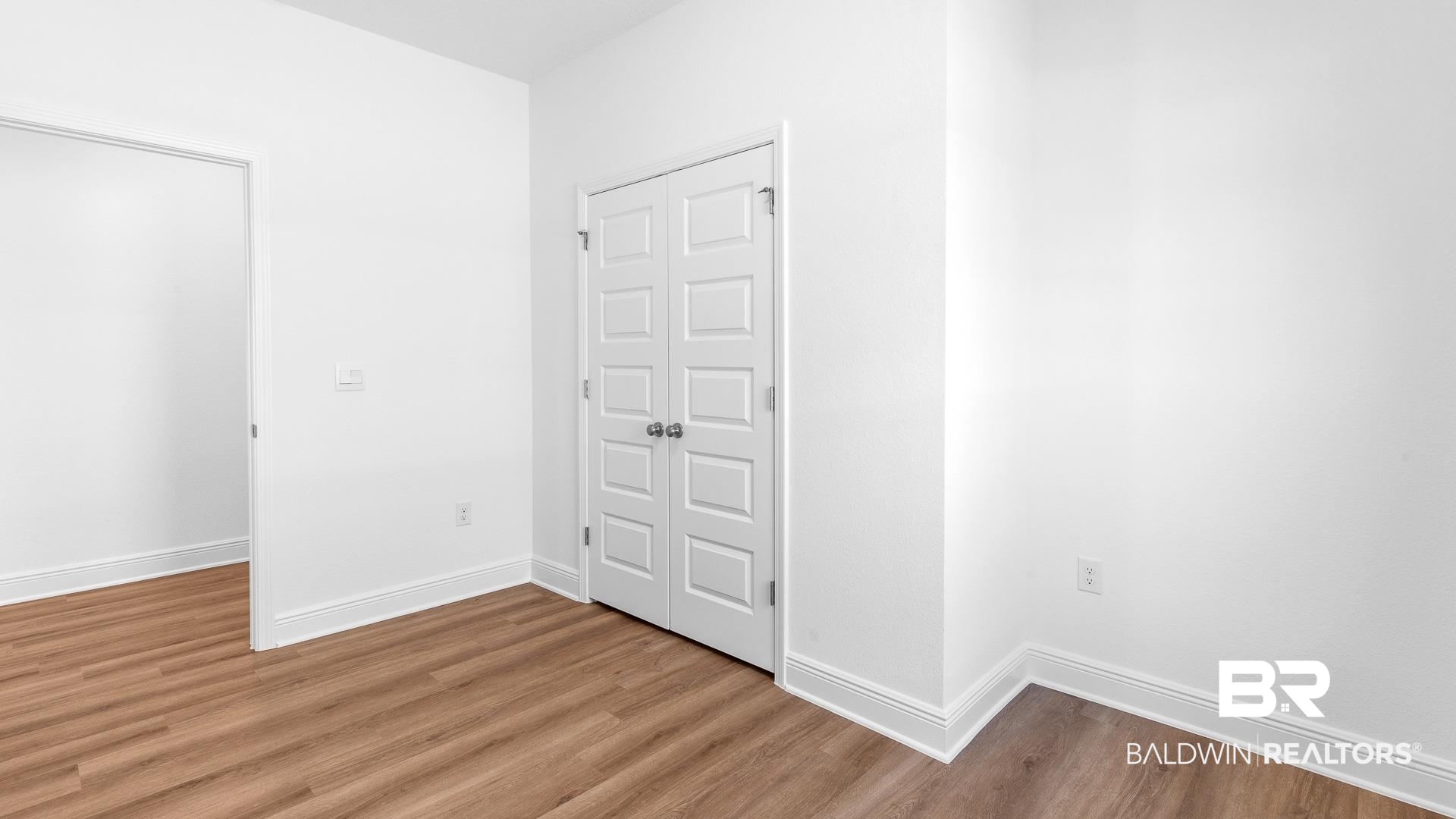 12931 Grand Rpds Road Fairhope, AL 36532 - Photo 9 of 33 Unfurnished bedroom with light wood-type flooring, baseboards, and a closet