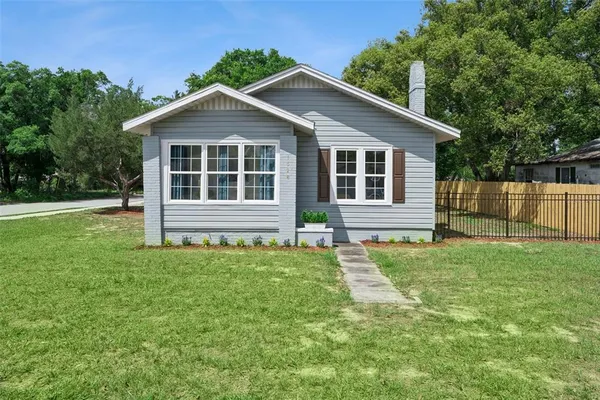 a house with green field in front of it