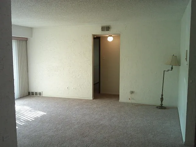 a view of empty room with floor to ceiling window