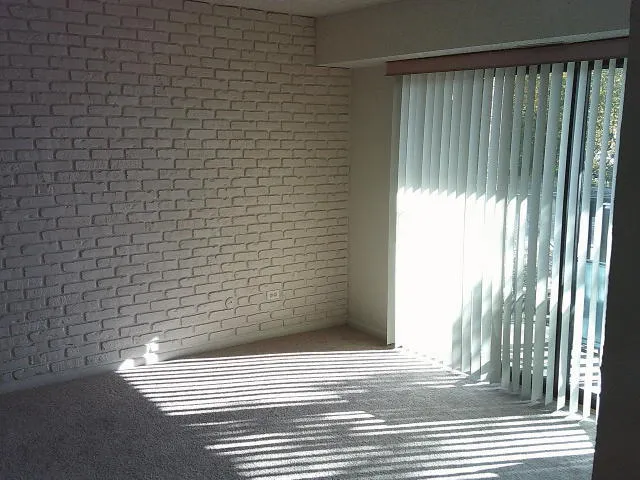 a view of livingroom and hallway with chandelier
