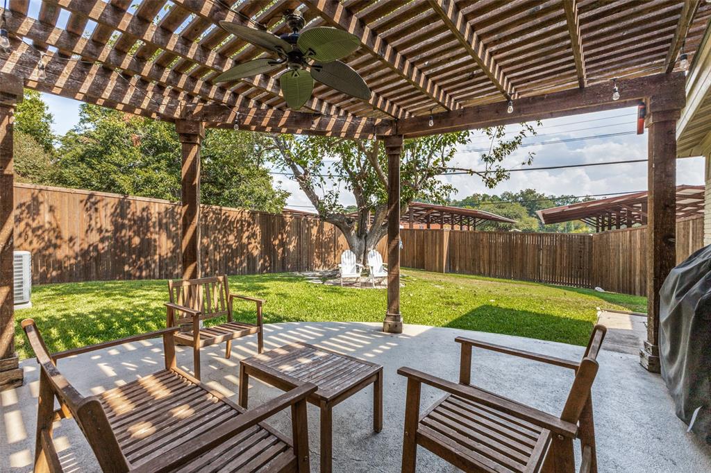 9864 Shoreview Road Dallas, TX 75238 - Photo 22 of 24 Expansive outdoor patio with a wooden pergola, ceiling fan, and string lighting