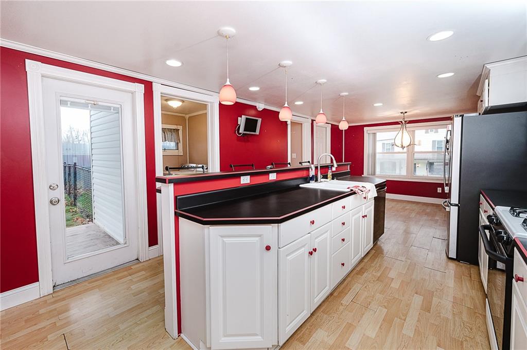 228 Harrison Avenue Robinson, PA 15949 - Photo 11 of 46 a kitchen with stainless steel appliances a sink stove and wooden floor