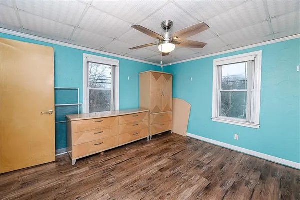 a view of room with window and wooden floor