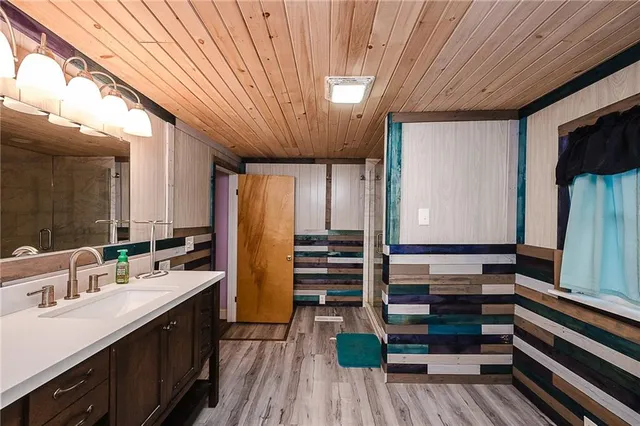 a bathroom with a sink a mirror and shower