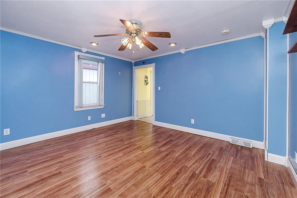 228 Harrison Avenue Robinson, PA 15949 - Photo 31 of 46 a view of an empty room with wooden floor and a window