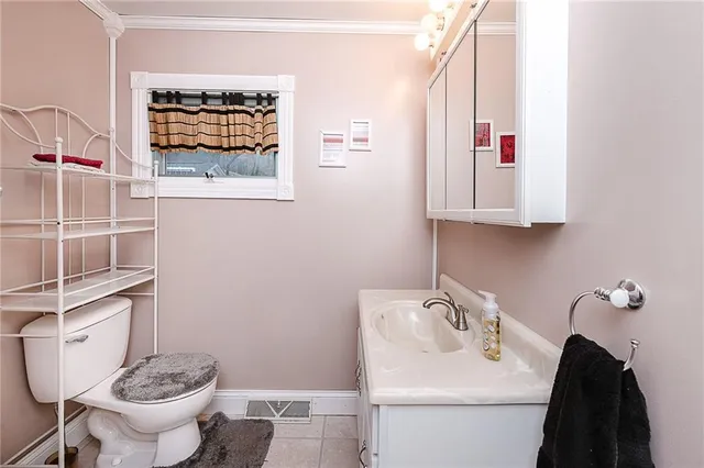 a bathroom with a toilet a sink and mirror