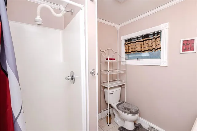 a white toilet sitting next to a small bathroom