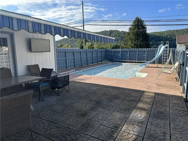 a view of a backyard with furniture and iron fence