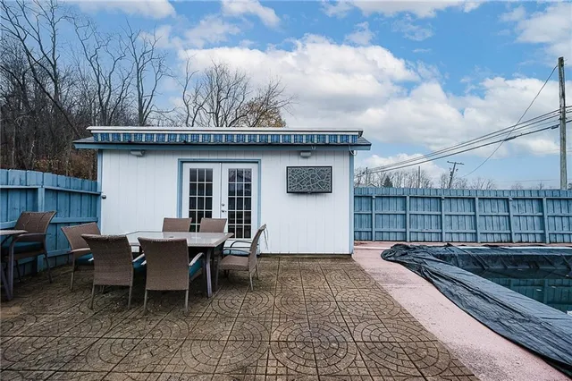 a backyard of a house with table and chairs