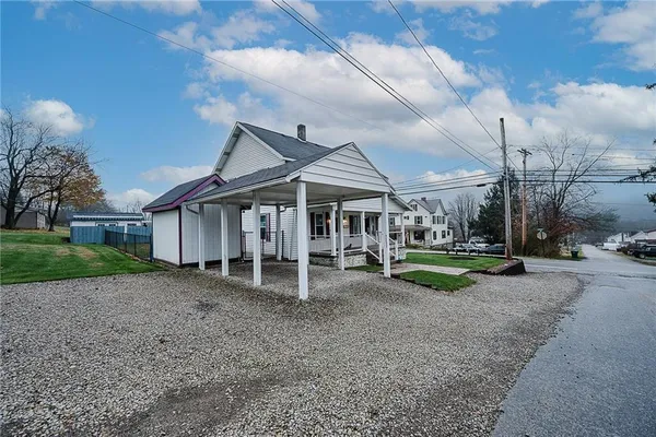 a view of a house with a yard and sitting area