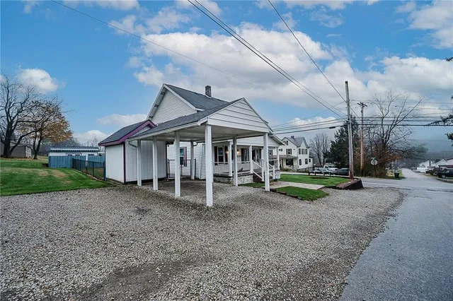 a view of a house with a yard and sitting area