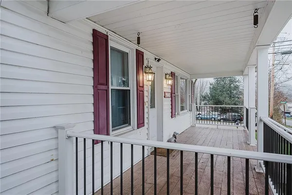 a view of a house with backyard and wooden fence