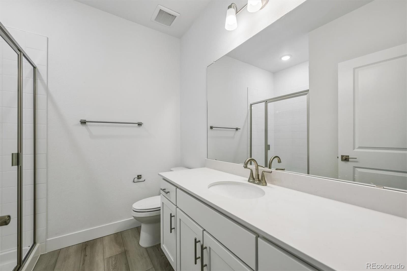 2516 West Bitterroot Place Highlands Ranch, CO 80129 - Photo 21 of 24 a bathroom with a sink a toilet and shower