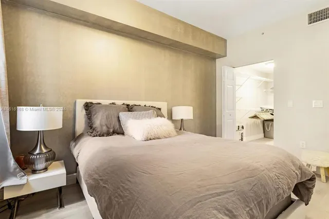 a bedroom with a bed and a lamp on table