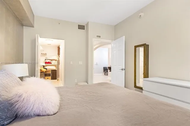 a en suite bathroom with a large bed and a large mirror