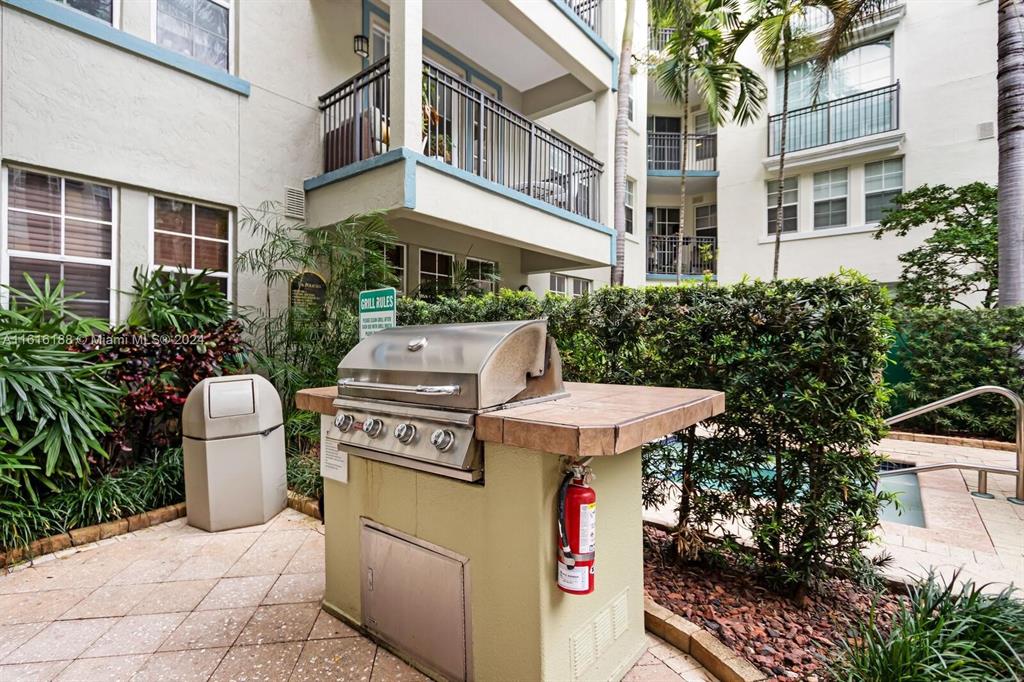 533 Northeast 3rd Avenue, Unit 229 Fort Lauderdale, FL 33301 - Photo 21 of 24 a view of a patio with table and chairs and potted plants
