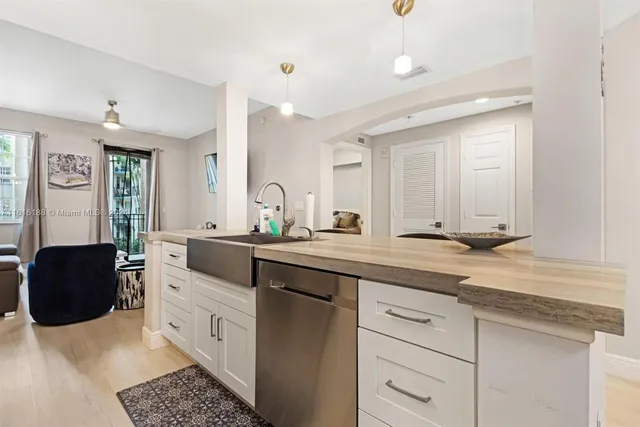 a kitchen with a sink and cabinets