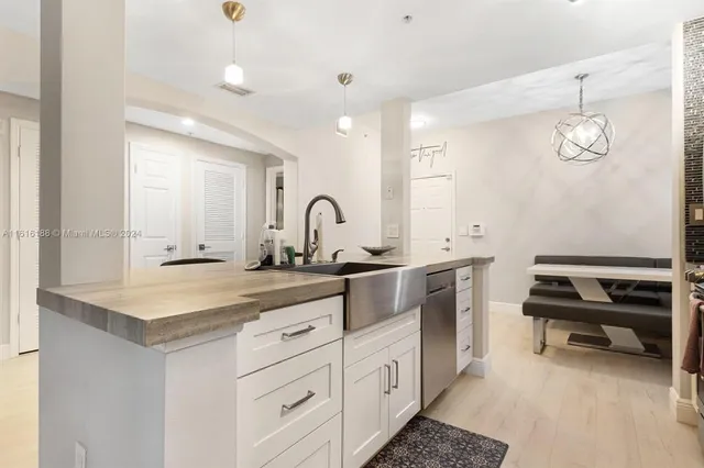 a spacious bathroom with a sink a toilet and a mirror