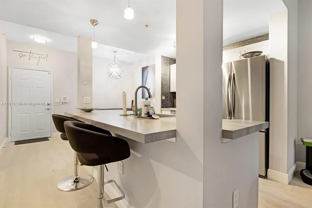 a dining room with table chairs and wooden floor