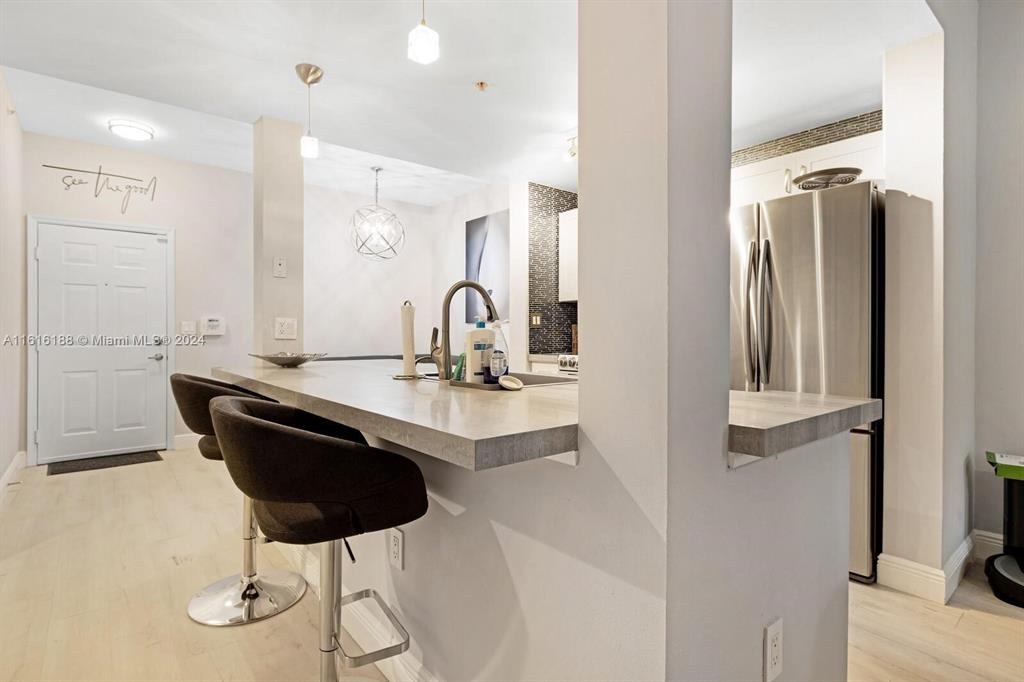 533 Northeast 3rd Avenue, Unit 229 Fort Lauderdale, FL 33301 - Photo 7 of 24 a dining room with table chairs and wooden floor