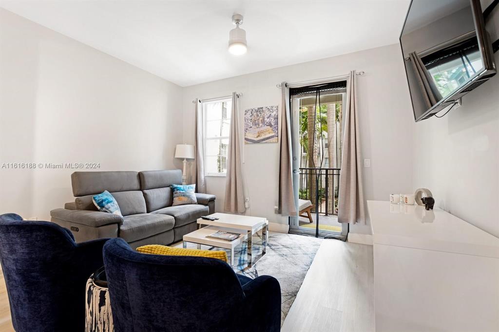 533 Northeast 3rd Avenue, Unit 229 Fort Lauderdale, FL 33301 - Photo 8 of 24 a living room with furniture and a flat screen tv