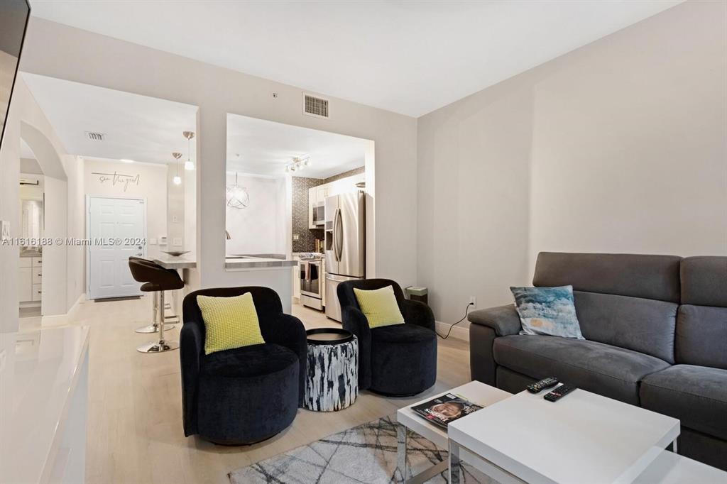 533 Northeast 3rd Avenue, Unit 229 Fort Lauderdale, FL 33301 - Photo 10 of 24 a living room with furniture and a table