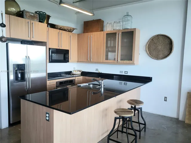 a kitchen with a refrigerator and a sink