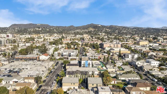an aerial view of residential houses with city view