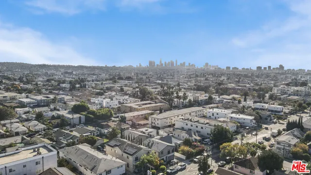 a large kitchen with stainless steel appliances a refrigerator and a sink