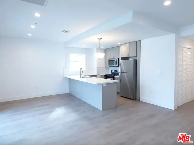 a bathroom with a sink a large mirror and a shower
