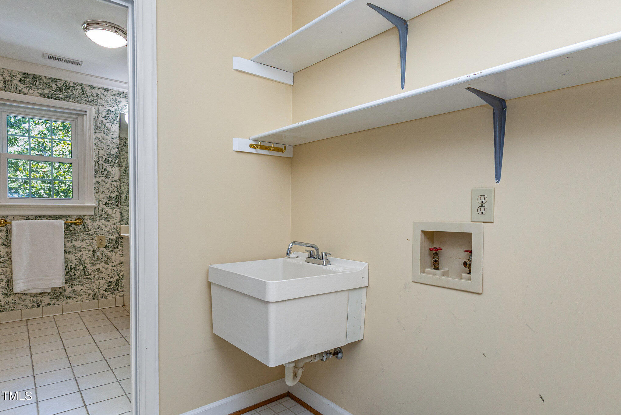 6909 Brook Ridge Court Raleigh, NC 27615 - Photo 22 of 60 Laundry room located off the primary bath and has a beautiful skylight in the ceiling