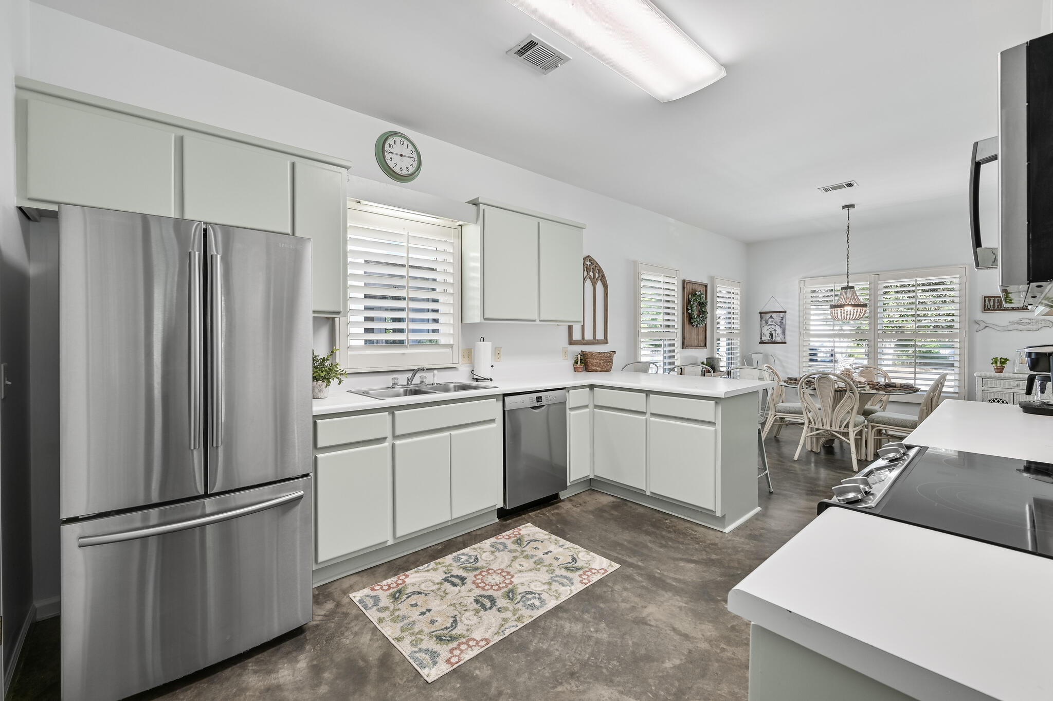65 Cassine Way Santa Rosa Beach, FL 32459 - Photo 15 of 38 a kitchen with a refrigerator and white cabinets