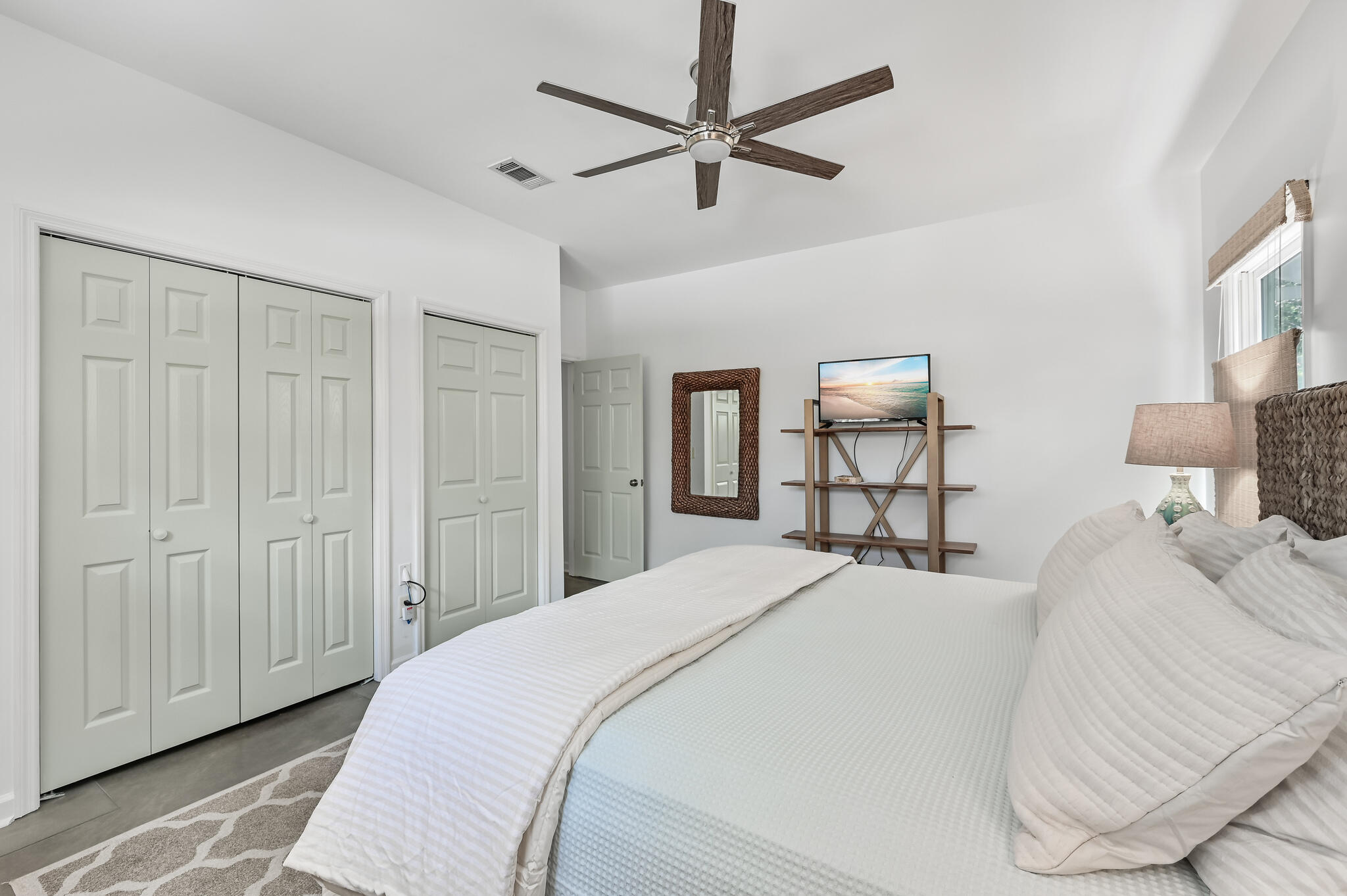 65 Cassine Way Santa Rosa Beach, FL 32459 - Photo 17 of 38 a bedroom with a bed and a chandelier