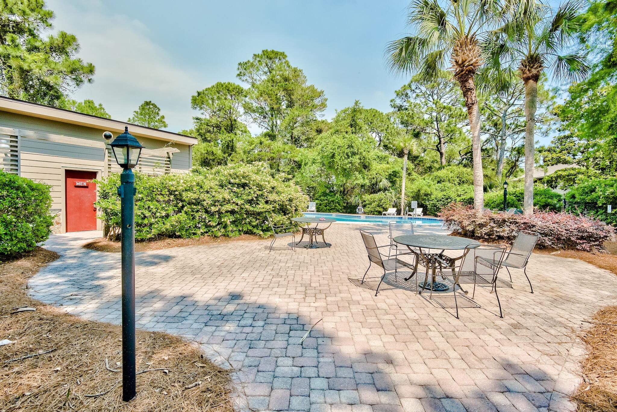 65 Cassine Way Santa Rosa Beach, FL 32459 - Photo 31 of 38 a view of a patio with table and chairs and potted plants