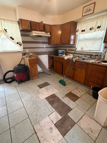 a kitchen with a stove a sink and a cabinets