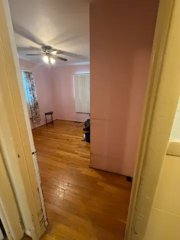 a view of a room with wooden floor and windows