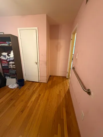 a bedroom with bed and a mirror