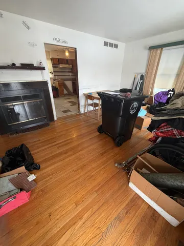 a room with gym equipment and wooden floor