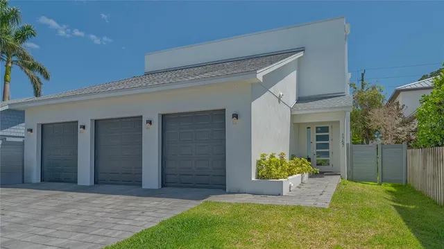 a front view of a house with a garden