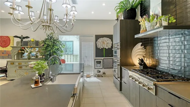 a kitchen with stainless steel appliances a stove sink and microwave
