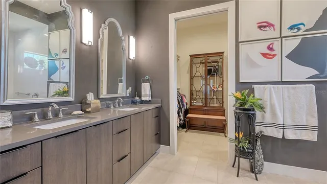 a bathroom with a sink a toilet a large mirror and shower