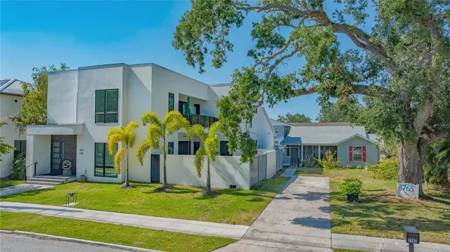 a living room with furniture a flat screen tv and a floor to ceiling window