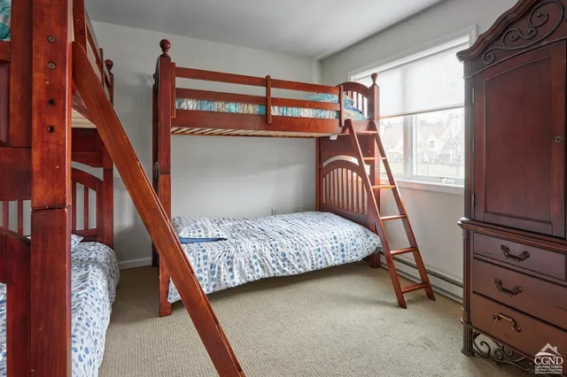 a bedroom with a bed next to a window